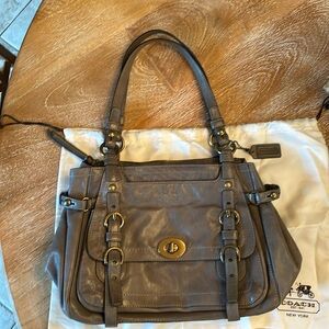 Coach leather shoulder bag with iconic striped fabric interior